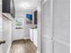 Well-lit laundry room with washer, dryer, storage, and a door to the outside, perfect for convenience at 12714 Tyler Run Ave, Odessa, FL 33556