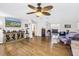 Open-concept living room featuring hardwood floors, an entertainment center, and ample space for seating at 12714 Tyler Run Ave, Odessa, FL 33556