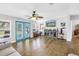 Comfortable living room with hardwood floors, turquoise doors, and a stylish entertainment center at 12714 Tyler Run Ave, Odessa, FL 33556