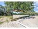 Outdoor sand arena with large mirrors for training, surrounded by well-maintained green grass and mature trees at 12714 Tyler Run Ave, Odessa, FL 33556