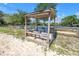 Covered outdoor seating area with chairs, offering a comfortable space to relax and enjoy the equestrian surroundings at 12714 Tyler Run Ave, Odessa, FL 33556