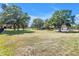 A sprawling estate featuring a residence, barn, garage, and lush greenery, providing a peaceful and expansive environment at 12714 Tyler Run Ave, Odessa, FL 33556