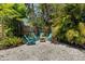 Charming backyard with gravel, lush greenery, and comfortable outdoor seating at 139 Adair Ave, Sarasota, FL 34243