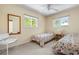 Cozy bedroom featuring twin beds with floral patterns, complemented by light-colored walls, and bright, natural light at 139 Adair Ave, Sarasota, FL 34243
