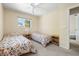 Charming bedroom featuring twin beds with floral spreads, light walls, a ceiling fan and a window with a view at 139 Adair Ave, Sarasota, FL 34243