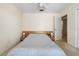 Bedroom featuring a ceiling fan, built-in lamps above the bed, and an open door that leads to a bathroom at 139 Adair Ave, Sarasota, FL 34243