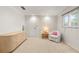 Bright bedroom featuring neutral carpet, white walls, and a cozy chair near a window, providing a relaxing space at 139 Adair Ave, Sarasota, FL 34243