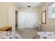 Bedroom with floral patterned twin beds, neutral walls, and view into connecting room at 139 Adair Ave, Sarasota, FL 34243