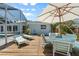 Outdoor seating with deck and sun umbrella near pool at 139 Adair Ave, Sarasota, FL 34243