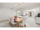 Open-concept dining area flowing into the kitchen with white tile floors at 139 Adair Ave, Sarasota, FL 34243