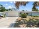 Charming single-story home with a well-manicured lawn, mature trees, and an attached two-car garage at 139 Adair Ave, Sarasota, FL 34243
