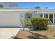Charming front view of home with manicured bushes and a white garage door at 139 Adair Ave, Sarasota, FL 34243