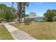Well-maintained single-story home with a lawn, mature trees, and a traditional front yard at 139 Adair Ave, Sarasota, FL 34243