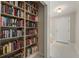 Hallway featuring floor-to-ceiling bookcase and a welcoming front entrance at 139 Adair Ave, Sarasota, FL 34243