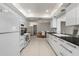Modern kitchen with white cabinetry and black countertops, open to dining area at 139 Adair Ave, Sarasota, FL 34243