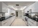 Spacious kitchen with white cabinets, black countertops, and modern appliances at 139 Adair Ave, Sarasota, FL 34243