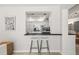 Modern kitchen featuring sleek countertops and bar seating, perfect for casual dining and entertaining at 139 Adair Ave, Sarasota, FL 34243
