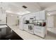 Modern kitchen with white cabinetry, black countertops, and stainless steel appliances at 139 Adair Ave, Sarasota, FL 34243