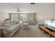 Cozy living room with poolside access, comfortable furniture, and a large television at 139 Adair Ave, Sarasota, FL 34243