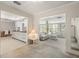 Bright living room featuring a modern kitchen and poolside view through large windows at 139 Adair Ave, Sarasota, FL 34243