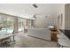 Open-concept living area with a sliding glass doors to the pool and access to the kitchen bar at 139 Adair Ave, Sarasota, FL 34243