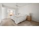 A bright bedroom with a ceiling fan, and a view of a lounge space through an archway at 139 Adair Ave, Sarasota, FL 34243
