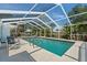 Inviting screened-in pool area with an in-ground pool and poolside seating for relaxing at 139 Adair Ave, Sarasota, FL 34243