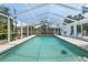 Clear swimming pool with screened enclosure and outdoor seating at 139 Adair Ave, Sarasota, FL 34243