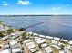 Stunning aerial view of a waterfront neighborhood with a long pier extending into the water at 14 Braden Castle Dr, Bradenton, FL 34208