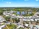 Community aerial showing a pond surrounded by lush trees and meticulously maintained residences at 14 Braden Castle Dr, Bradenton, FL 34208