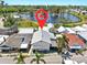 An aerial view shows the property's location near a beautiful pond and lush greenery at 14 Braden Castle Dr, Bradenton, FL 34208