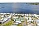 An aerial shot displays a waterfront community and their lovely shuffleboard courts at 14 Braden Castle Dr, Bradenton, FL 34208