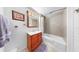 Bathroom featuring tiled shower, wooden vanity, and ample lighting at 14 Braden Castle Dr, Bradenton, FL 34208