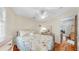 Cozy bedroom with hardwood floors, floral bedding, and a ceiling fan at 14 Braden Castle Dr, Bradenton, FL 34208