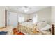Comfortable bedroom with a white ceiling fan, hardwood floors, and plenty of natural light at 14 Braden Castle Dr, Bradenton, FL 34208