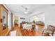 Dining room featuring hardwood floors, ceiling fan, and white walls with view to living room at 14 Braden Castle Dr, Bradenton, FL 34208