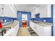 Modern kitchen with white cabinets and countertops, open to the dining area, offering a functional and stylish cooking space at 14 Braden Castle Dr, Bradenton, FL 34208