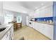 Bright white kitchen with stainless steel appliances, and view to an eat in dining space at 14 Braden Castle Dr, Bradenton, FL 34208