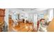 Spacious living area with hardwood floors, ceiling fans, view to a dining room and comfortable seating at 14 Braden Castle Dr, Bradenton, FL 34208