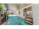 Charming covered patio with steps leading to a sliding door, perfect for relaxing and enjoying the outdoors at 14 Braden Castle Dr, Bradenton, FL 34208
