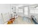 Bright sunroom featuring white shiplap walls, tile flooring, and a coastal-themed decor, offering a cozy retreat at 14 Braden Castle Dr, Bradenton, FL 34208