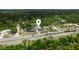 Aerial shot showcases the property's location surrounded by trees and other residential homes at 16834 Toledo Blade Blvd, Port Charlotte, FL 33954