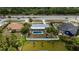 Aerial view of the property featuring a backyard pool and white fencing at 16834 Toledo Blade Blvd, Port Charlotte, FL 33954