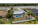 Aerial view of the property featuring a backyard pool and white fencing at 16834 Toledo Blade Blvd, Port Charlotte, FL 33954