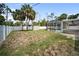 Backyard features white vinyl fence, pool, and trees at 16834 Toledo Blade Blvd, Port Charlotte, FL 33954