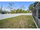 A fenced-in backyard with green grass and tropical landscaping providing privacy at 16834 Toledo Blade Blvd, Port Charlotte, FL 33954