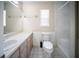 Well-lit bathroom with a single sink vanity, toilet, and shower/tub combo at 16834 Toledo Blade Blvd, Port Charlotte, FL 33954