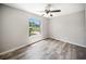 Bedroom with wood-look flooring, a window, and a ceiling fan at 16834 Toledo Blade Blvd, Port Charlotte, FL 33954