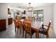 A large dining table with seating for eight sits between the kitchen and pool-facing sliding glass doors at 16834 Toledo Blade Blvd, Port Charlotte, FL 33954
