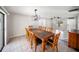 Open-plan dining room featuring tile floors, modern lighting, and a view of the living space at 16834 Toledo Blade Blvd, Port Charlotte, FL 33954